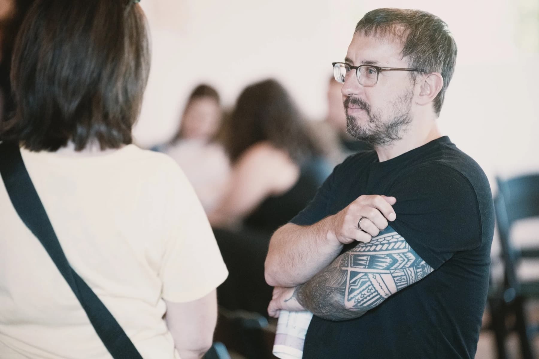 Two people in conversation at New Culture Church in Madison