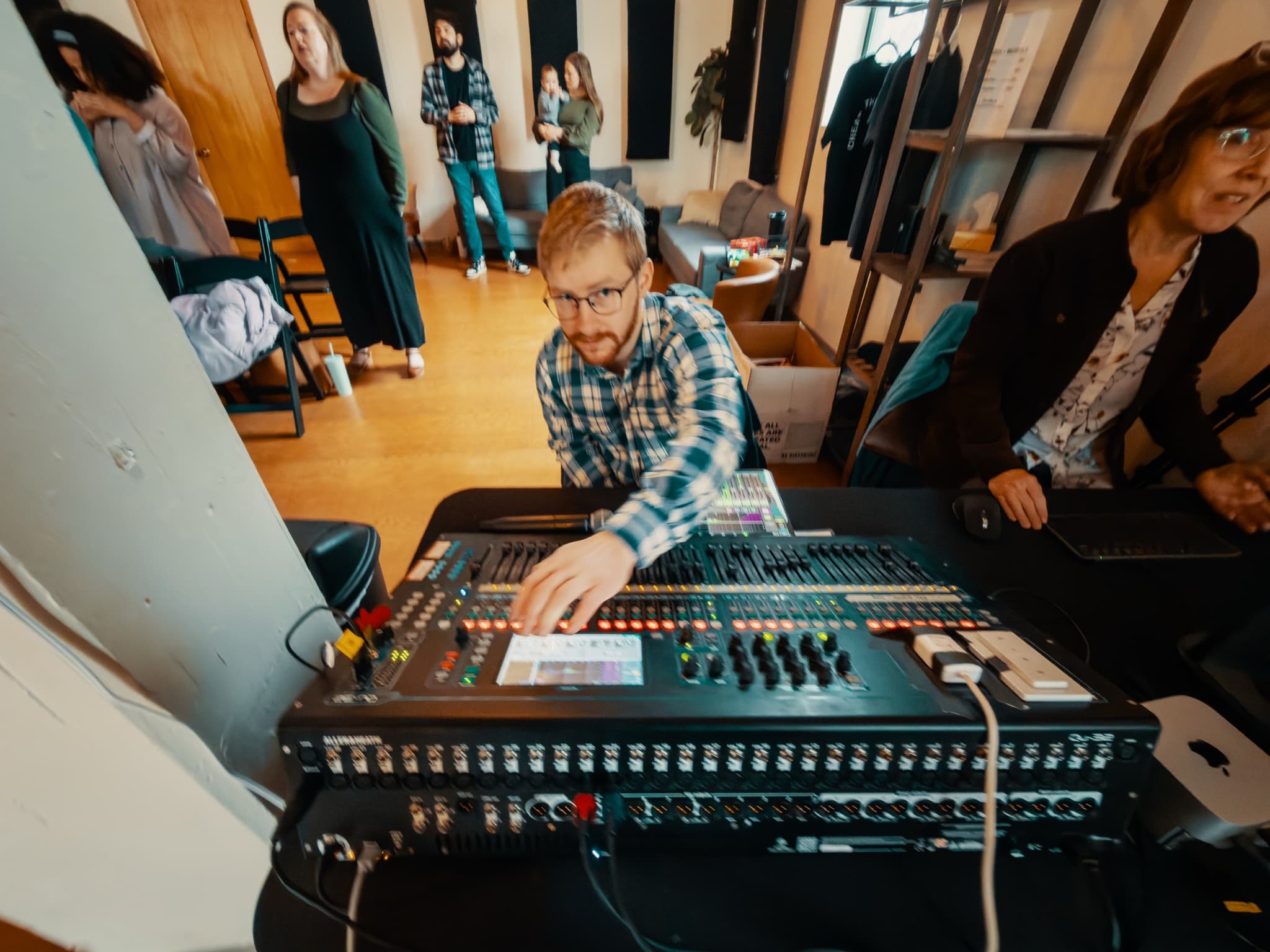 A New Culture Church volunteer running the sound board during a Sunday gathering in downtown Madison